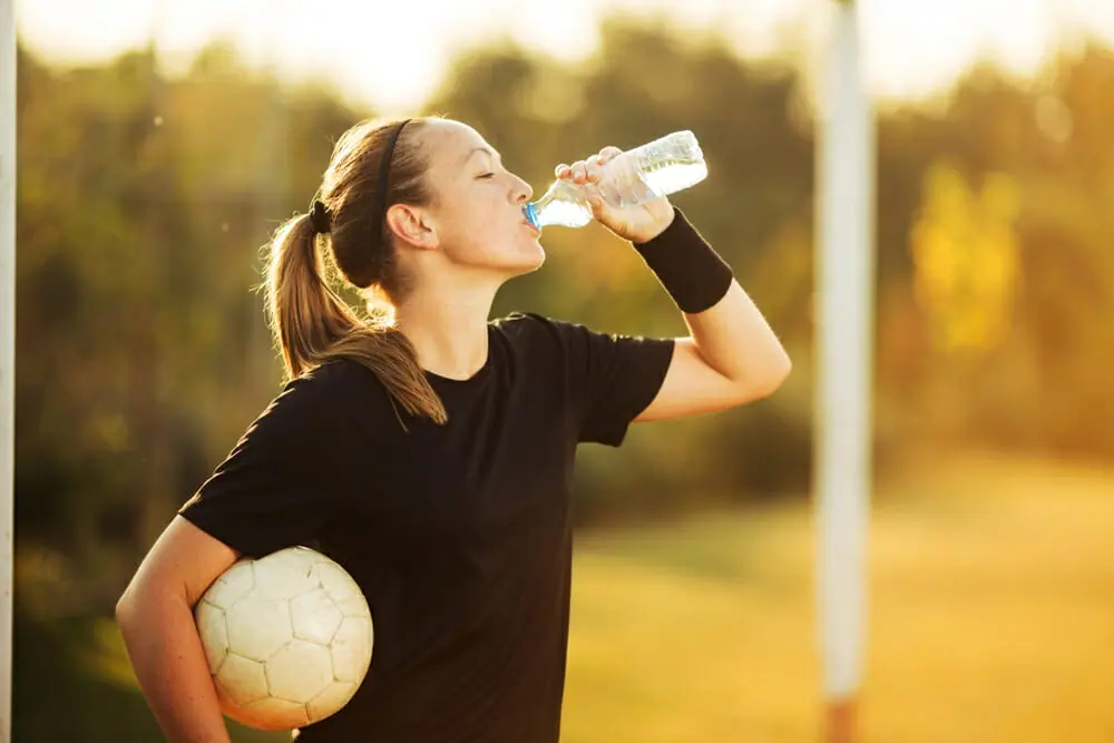Female Footballer Drinking Water